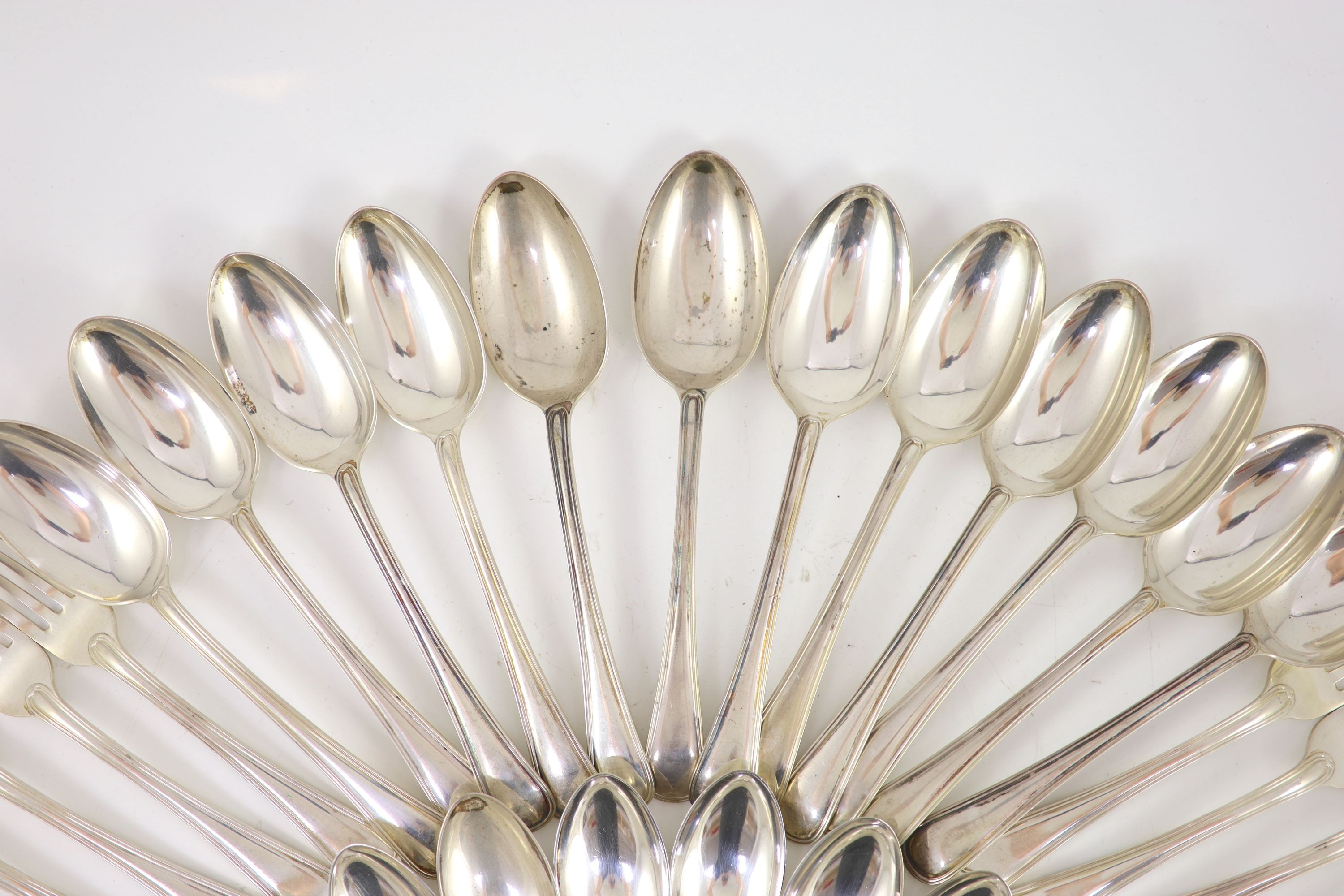 A part canteen of Edwardian silver Old English double struck thread pattern flatware for twelve by John Round & Son Ltd
